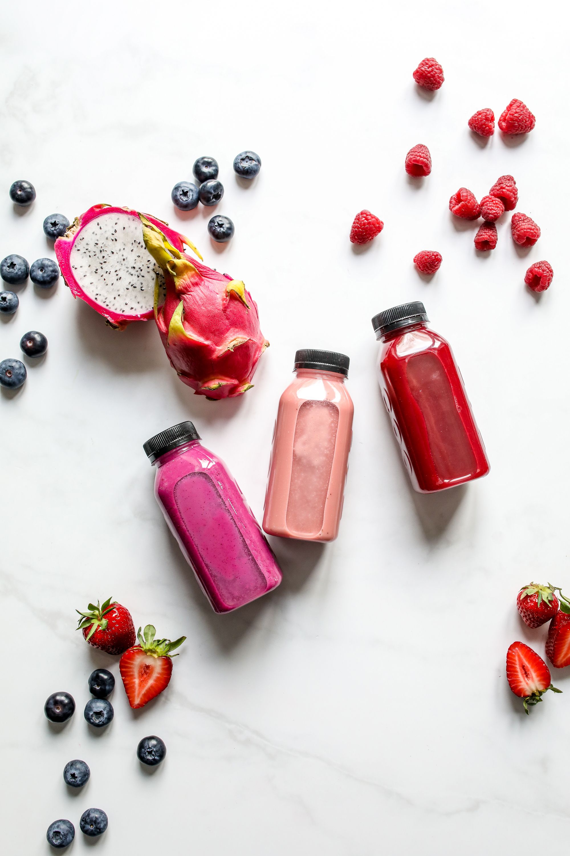 Colorful OyeJuice bottles with fresh fruit